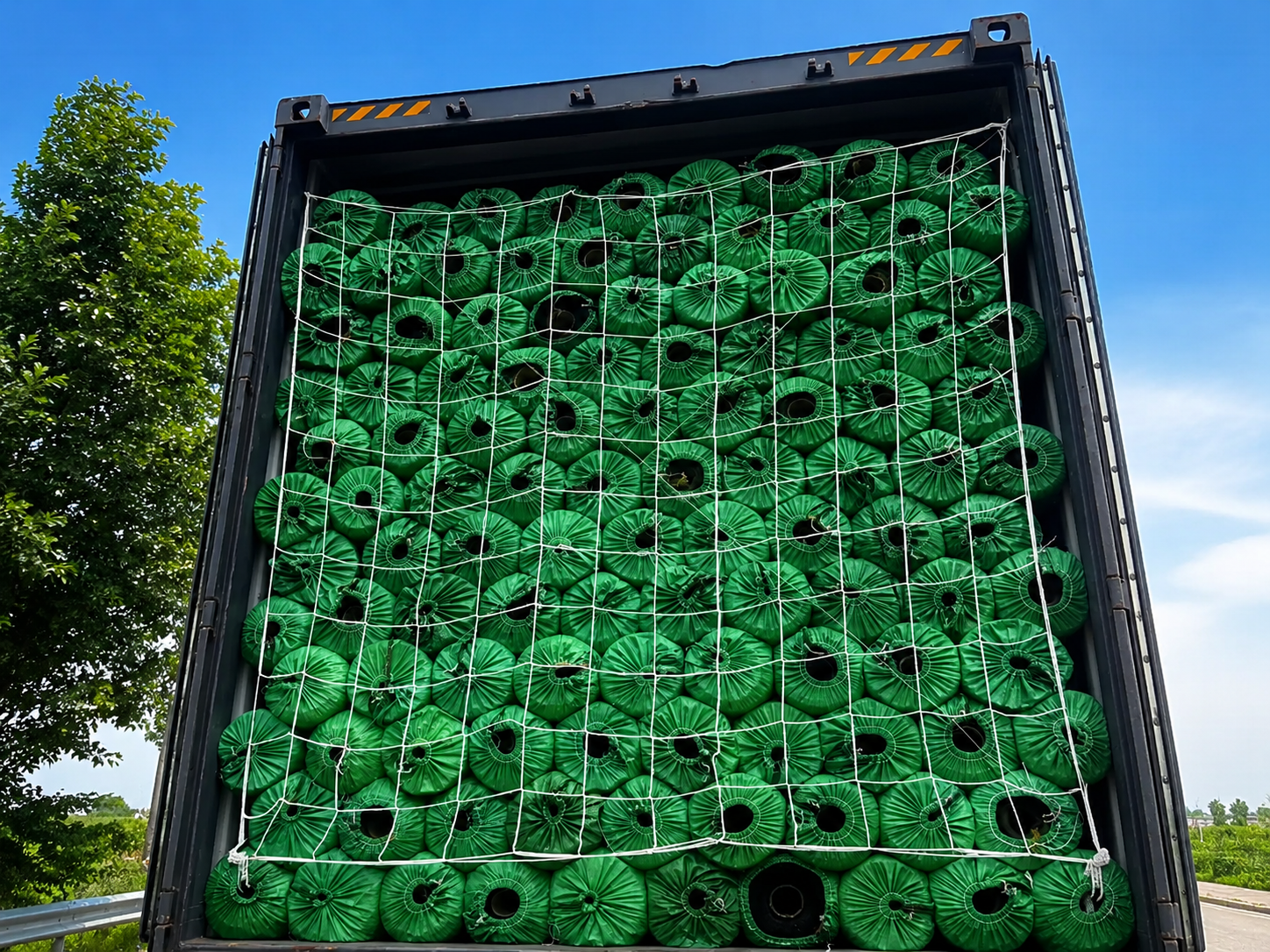 Artificial grass rolls arranged inside a shipping container