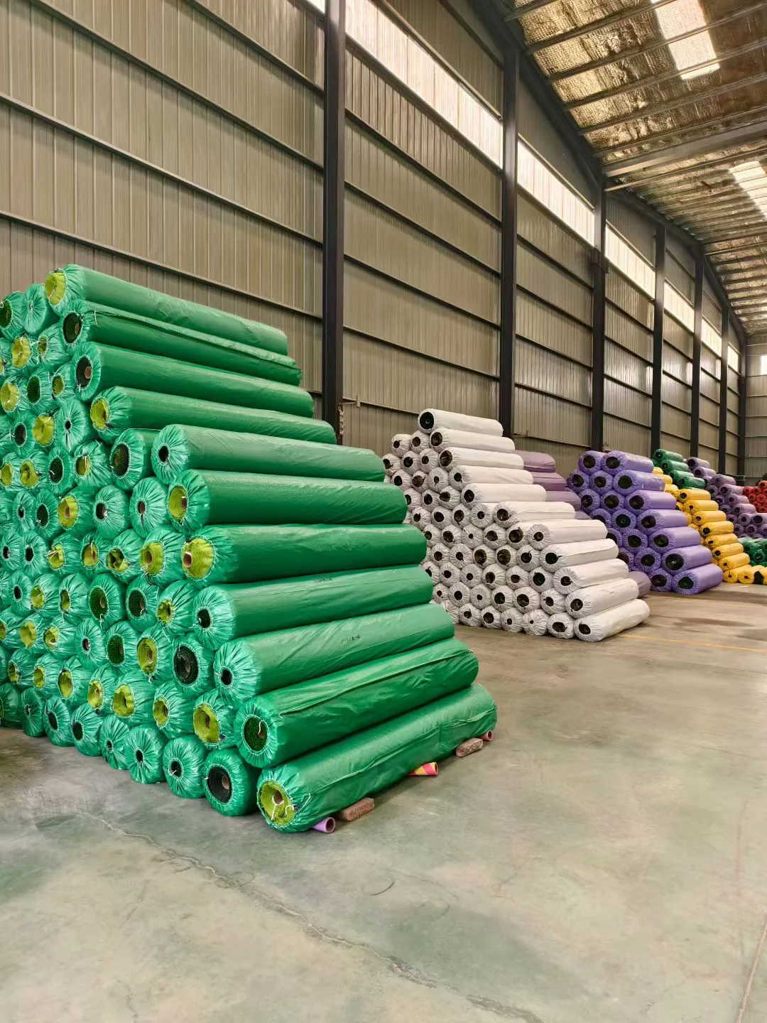 Artificial grass rolls stored in warehouse stock