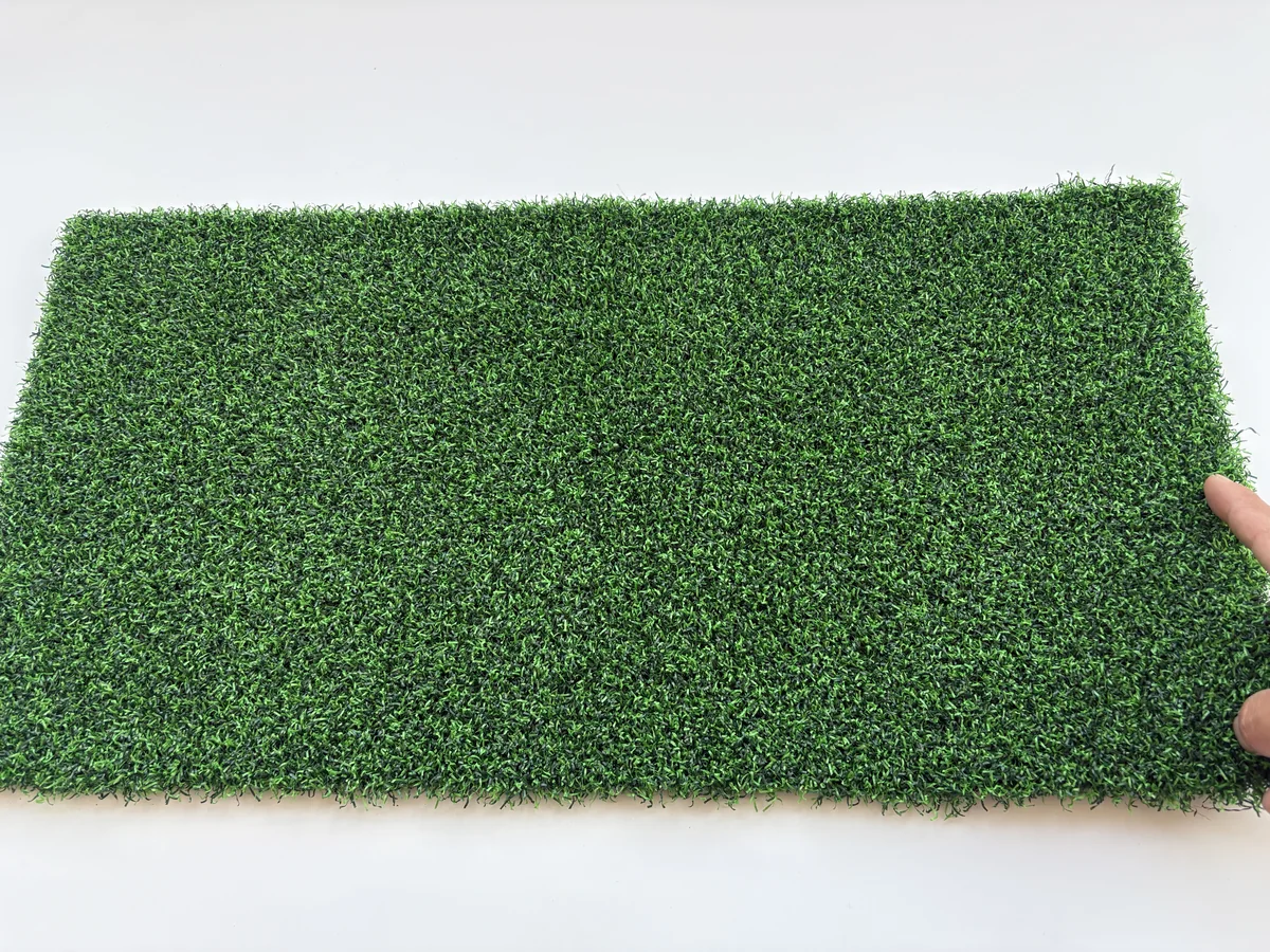 Putting green artificial grass hand scale and texture view