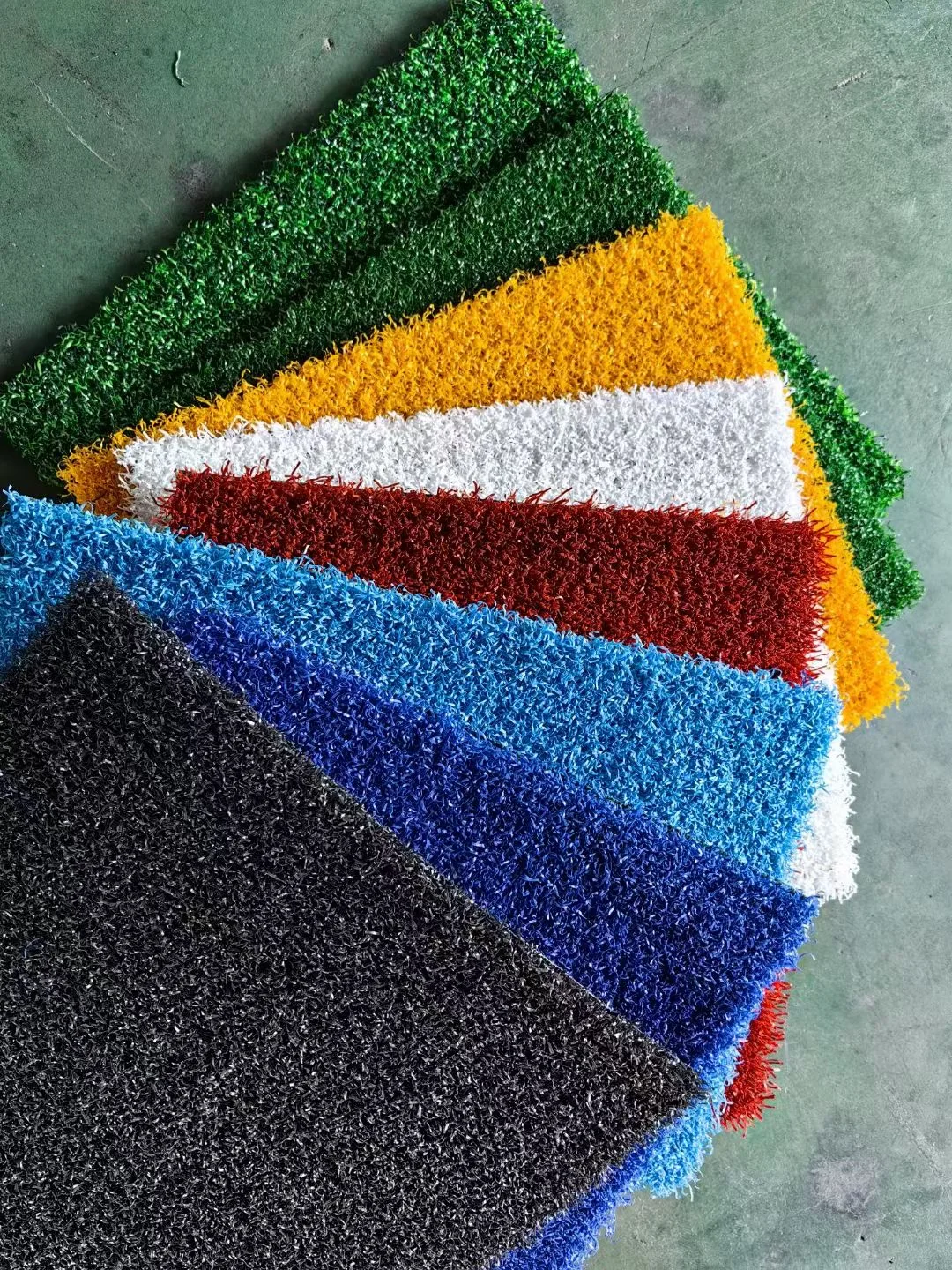 Artificial grass sample pieces in different color options